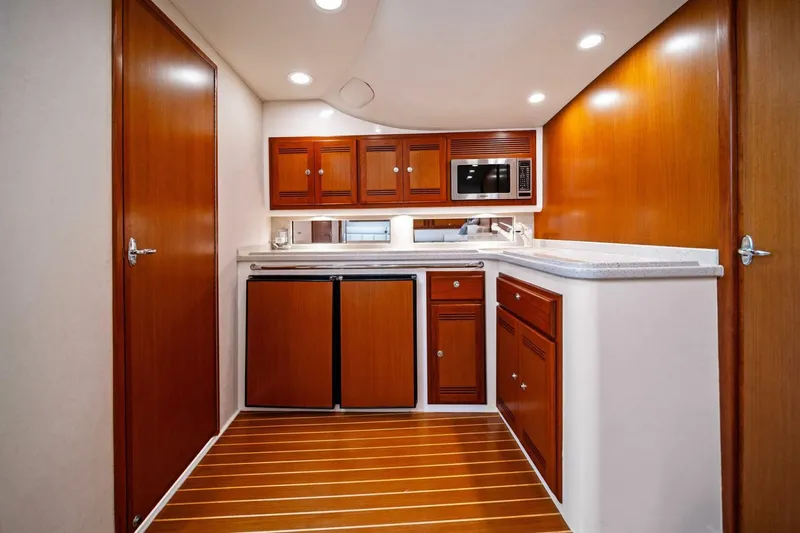 Miss B Havin Yacht Photos Pics 2005 Cabo 40 Express yacht interior with wooden cabinets and modern kitchen amenities.