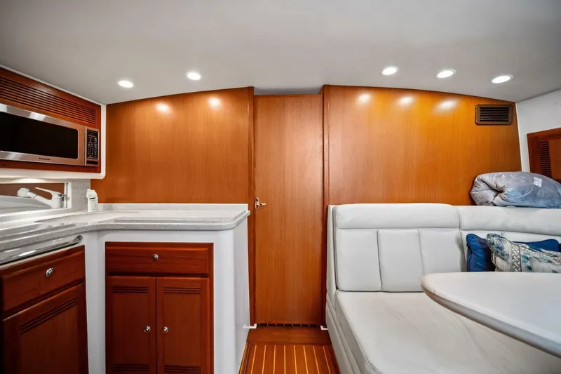 Miss B Havin Yacht Photos Pics Luxurious interior of 2005 Cabo 40 Express yacht with modern kitchen and seating area.