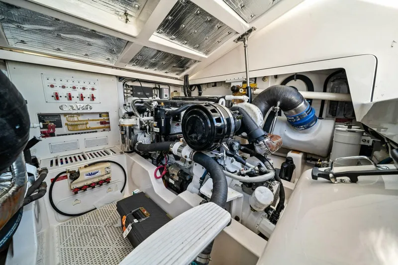 Miss B Havin Yacht Photos Pics Engine room of a 2005 Cabo 40 Express boat, showcasing mechanical components and systems.