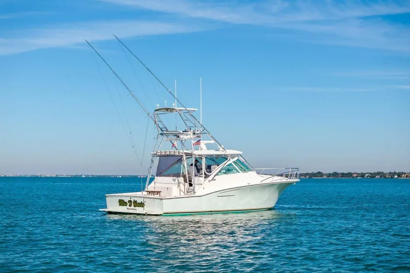 Miss B Havin Yacht Photos Pics 2005 Cabo 40 Express boat on calm blue water under clear sky.