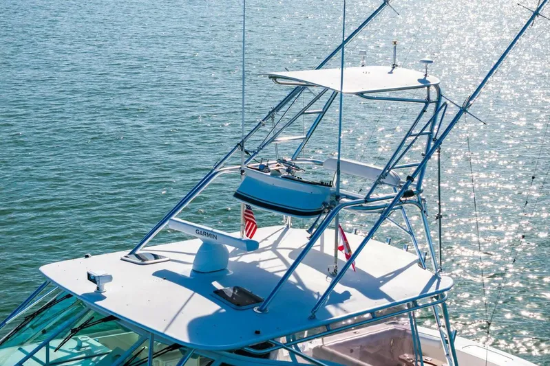 Miss B Havin Yacht Photos Pics 2005 Cabo 40 Express boat with tower on sparkling water.