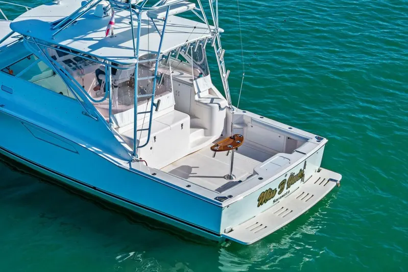 Miss B Havin Yacht Photos Pics 2005 Cabo 40 Express boat on clear blue water, featuring a spacious deck.