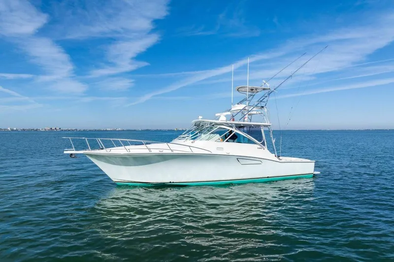 Miss B Havin Yacht Photos Pics 2005 Cabo 40 Express yacht on calm blue waters under clear sky.