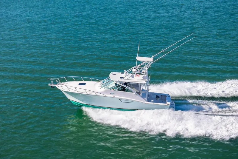 Miss B Havin Yacht Photos Pics 2005 Cabo 40 Express boat cruising on open water.