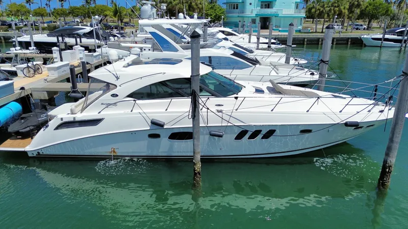  Yacht Photos Pics 2010 Sea Ray 540 Sundancer yacht docked in a marina, surrounded by other boats.