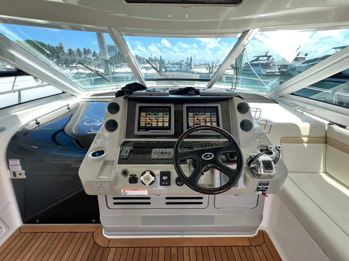  Yacht Photos Pics Helm of 2010 Sea Ray 540 Sundancer yacht with dual screens and wooden deck.