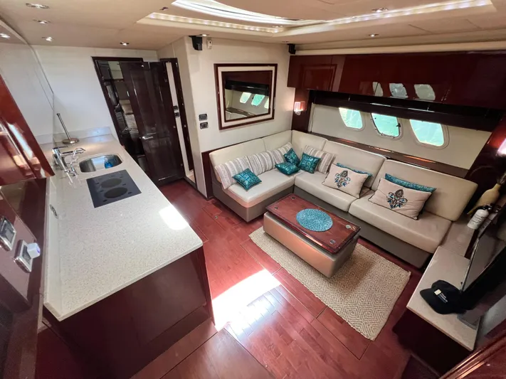  Yacht Photos Pics Luxurious interior of 2010 Sea Ray 540 Sundancer yacht with modern kitchen and cozy seating area.
