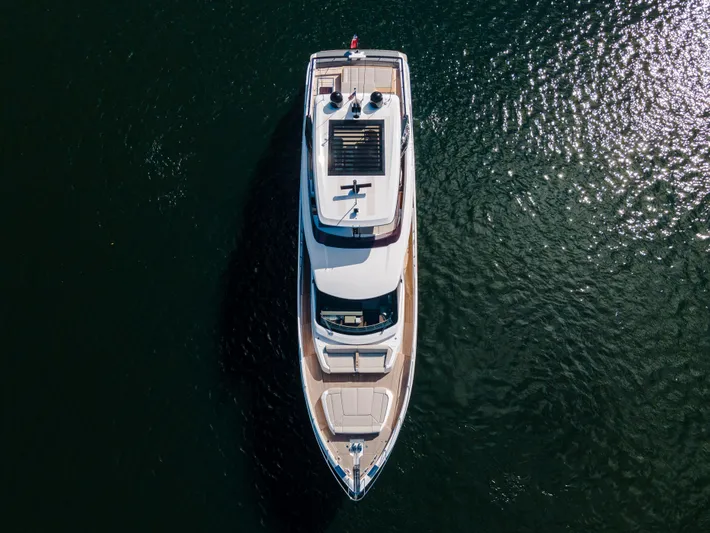  Yacht Photos Pics Aerial view of 2023 Ferretti Yachts 860 on shimmering water.