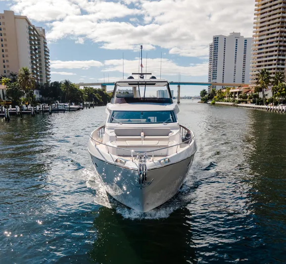  Yacht Photos Pics 2023 Ferretti Yachts 860 cruising in a sunny urban waterway.