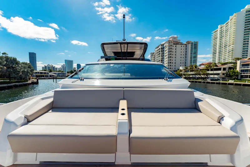  Yacht Photos Pics 2023 Ferretti Yachts 860, luxury yacht with spacious deck, city skyline backdrop.