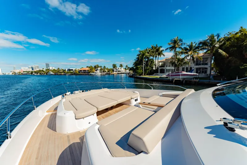  Yacht Photos Pics Luxurious 2023 Ferretti Yachts 860 on a sunny waterfront with palm trees.