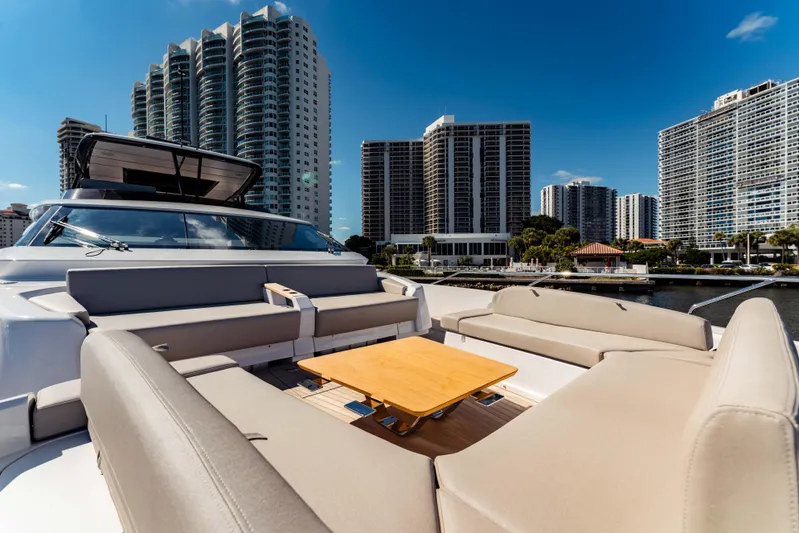  Yacht Photos Pics 2023 Ferretti Yachts 860 with luxurious seating, city skyline backdrop.