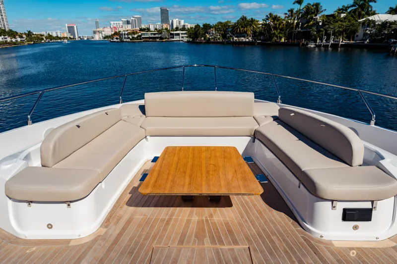  Yacht Photos Pics Luxury seating area on 2023 Ferretti Yachts 860, overlooking serene waterfront cityscape.