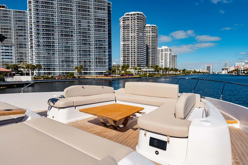  Yacht Photos Pics Luxurious 2023 Ferretti Yachts 860 with elegant deck seating, city skyline backdrop.