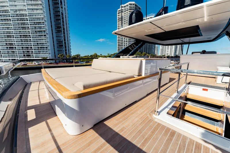  Yacht Photos Pics Luxurious 2023 Ferretti Yachts 860 deck with modern seating and cityscape backdrop.