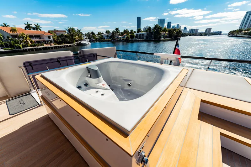  Yacht Photos Pics Luxurious 2023 Ferretti Yachts 860 with jacuzzi on deck, overlooking scenic waterfront.