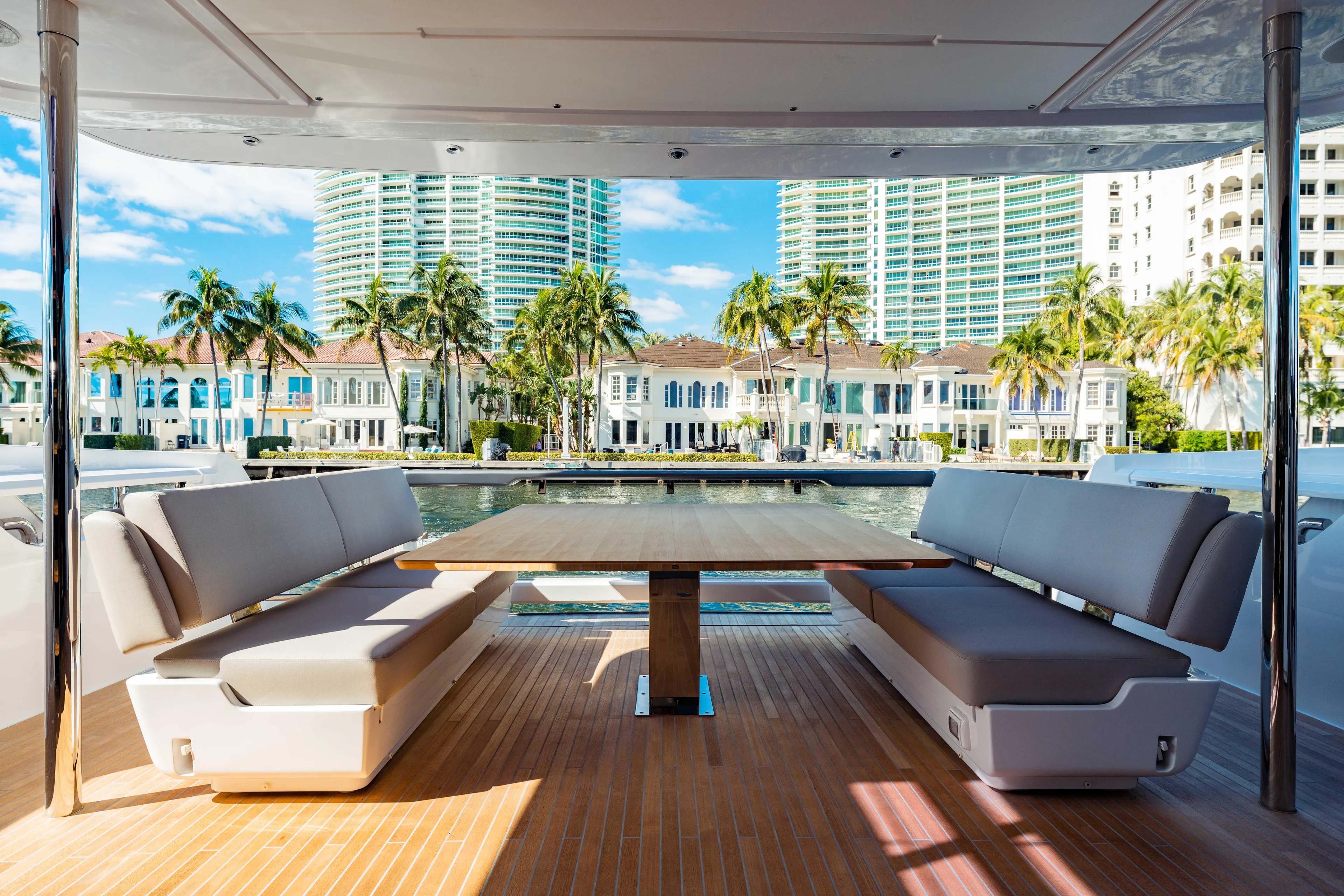  Yacht Photos Pics Luxury deck seating on 2023 Ferretti Yachts 860, with waterfront view and palm trees.