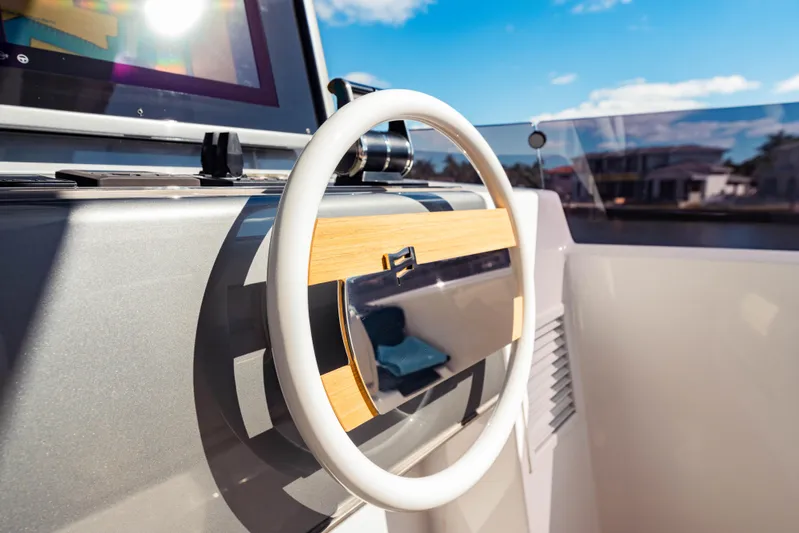  Yacht Photos Pics Steering wheel of 2023 Ferretti Yachts 860 under clear blue sky.