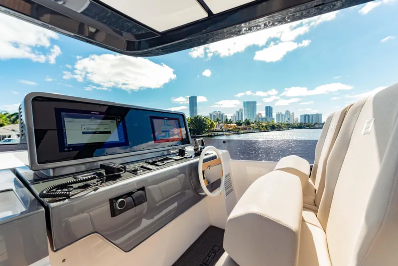  Yacht Photos Pics Luxurious 2023 Ferretti Yachts 860 helm with city skyline view.