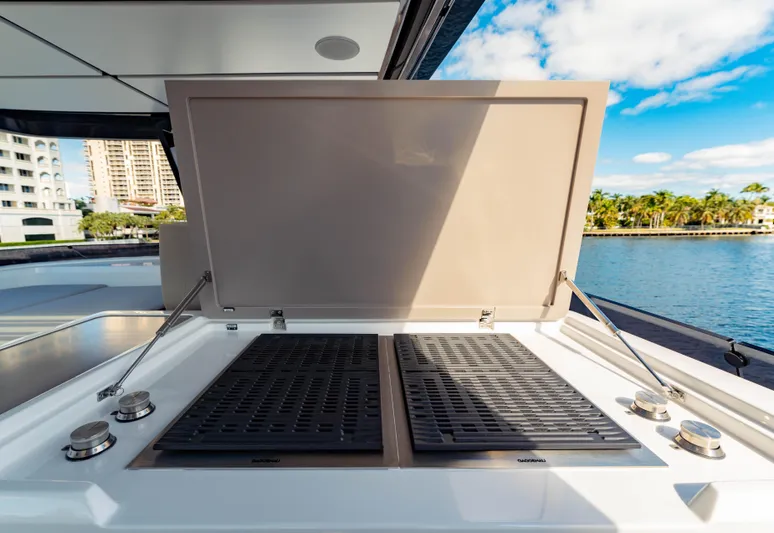  Yacht Photos Pics Outdoor grill on 2023 Ferretti Yachts 860, docked by waterfront with cityscape view.