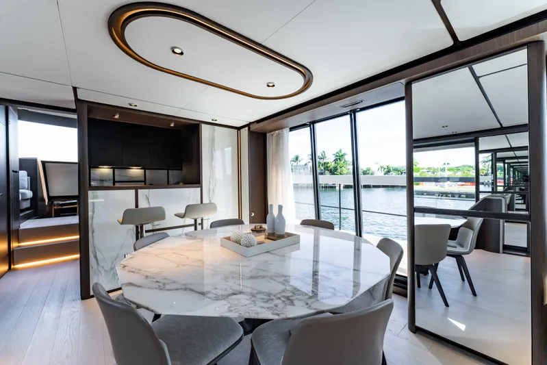  Yacht Photos Pics Luxurious interior of 2023 Ferretti Yachts 860 with elegant dining area and waterfront view.