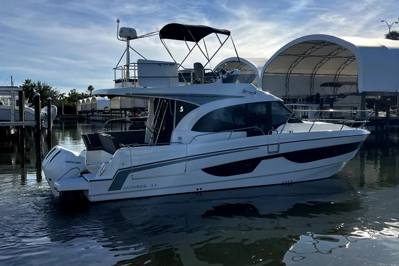  Yacht Photos Pics 2023 Beneteau Antares 11 Fly yacht docked in marina, side view.