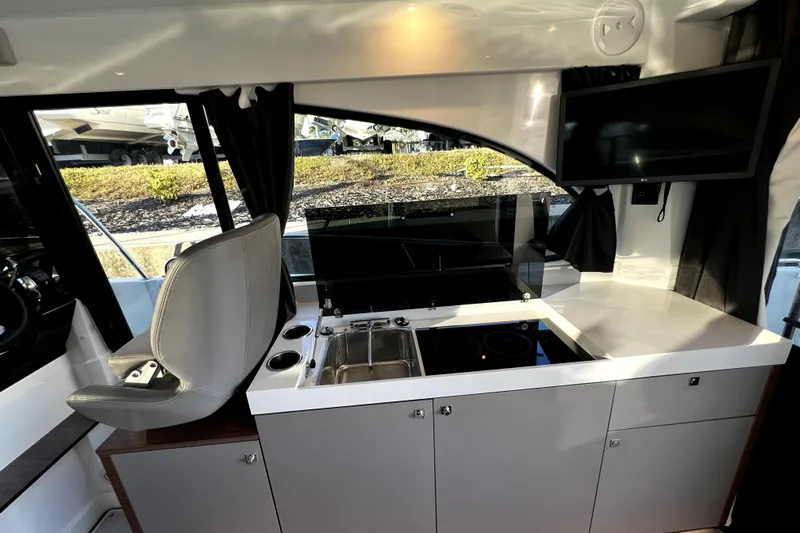  Yacht Photos Pics Interior of 2023 Beneteau Antares 11 Fly, featuring modern kitchen and seating area.