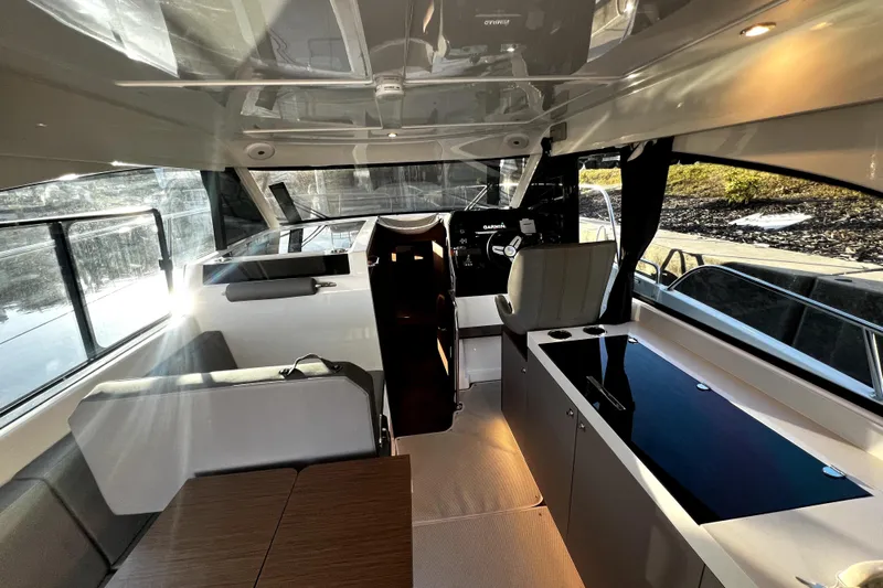  Yacht Photos Pics Interior of 2023 Beneteau Antares 11 Fly, featuring modern seating and navigation area.