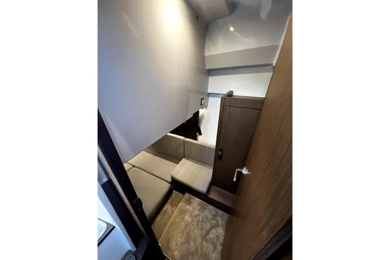  Yacht Photos Pics Interior cabin of 2023 Beneteau Antares 11 Fly, featuring cozy seating and wooden accents.