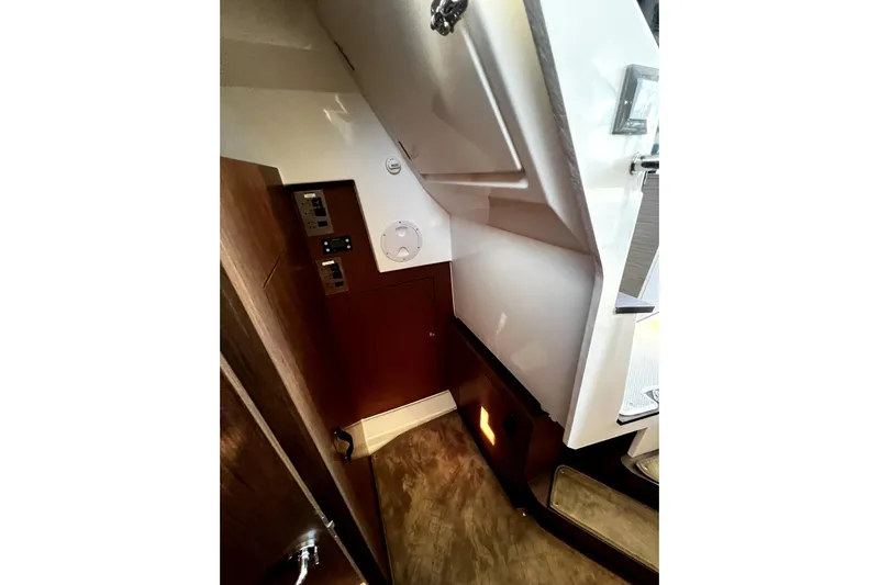  Yacht Photos Pics Interior view of 2023 Beneteau Antares 11 Fly, featuring wood paneling and control panels.