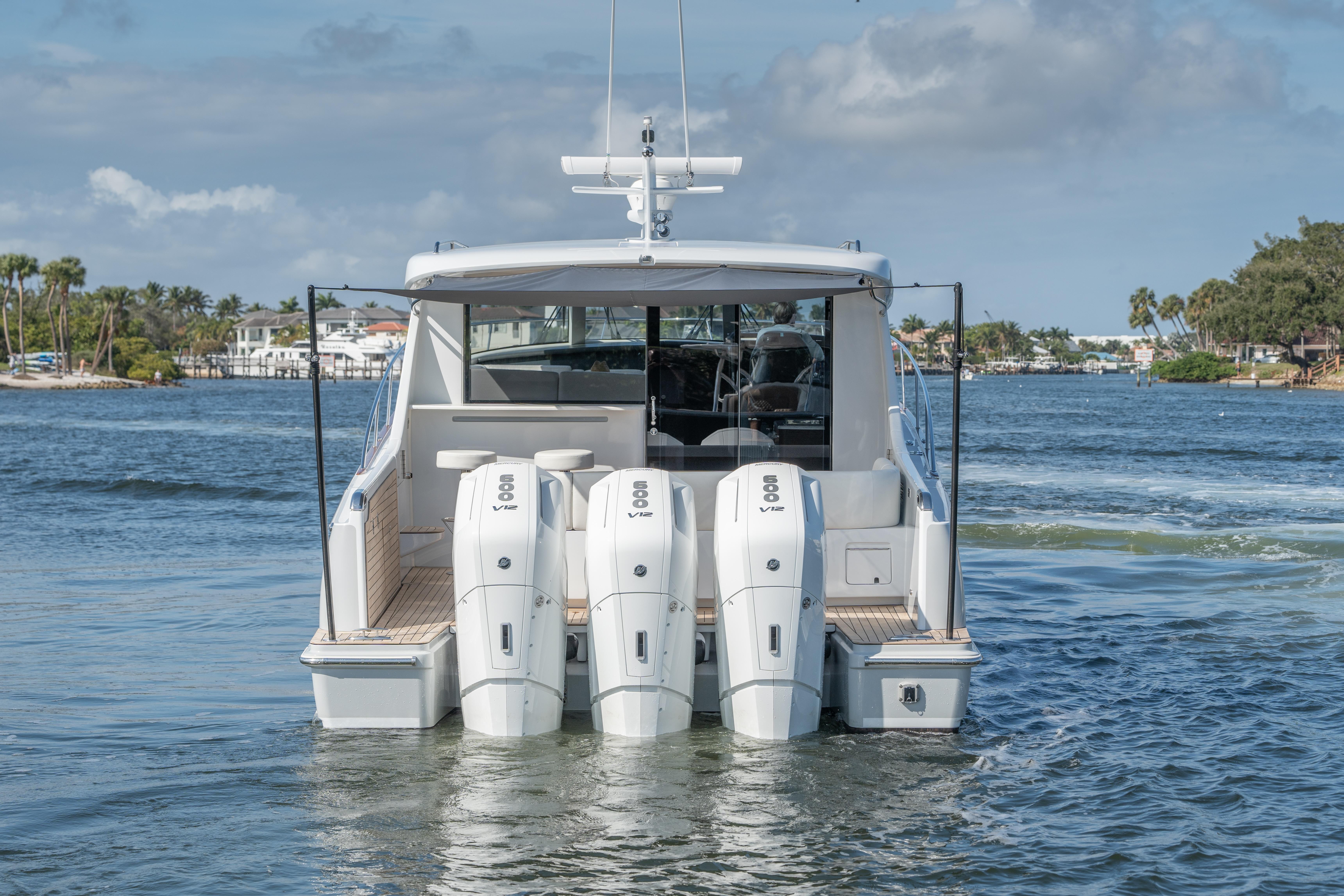 ECLIPSE 505 Shadow 2025 boat with triple outboard engines on a scenic waterway.