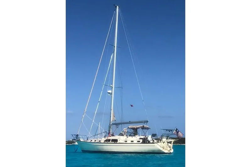  Yacht Photos Pics 2005 Island Packet 485 sailboat anchored in clear blue waters under a sunny sky.