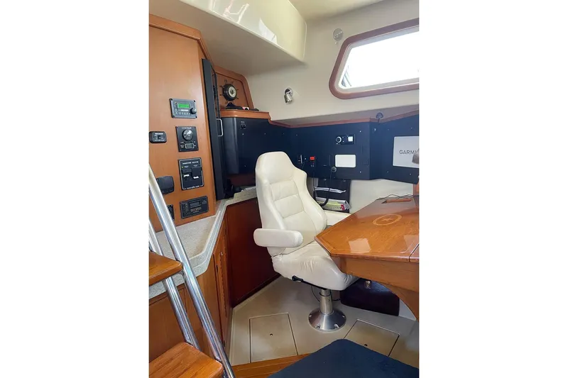  Yacht Photos Pics Interior of 2005 Island Packet 485 yacht with navigation station and white captain's chair.