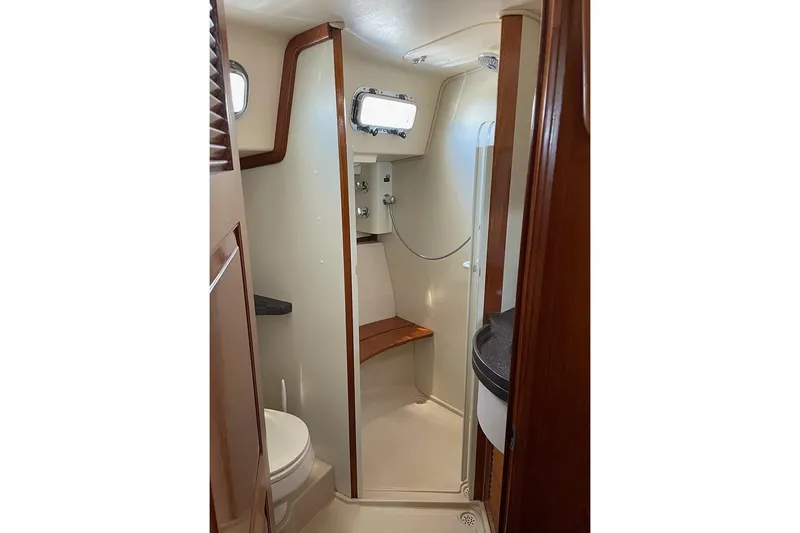  Yacht Photos Pics 2005 Island Packet 485 yacht bathroom with shower, toilet, and wooden accents.