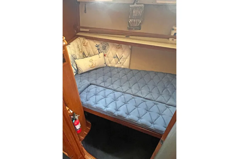  Yacht Photos Pics 2005 Island Packet 485 cabin with blue cushioned seating and nautical-themed pillows.