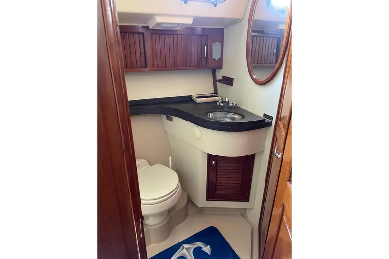  Yacht Photos Pics 2005 Island Packet 485 yacht bathroom with wooden cabinets and modern fixtures.