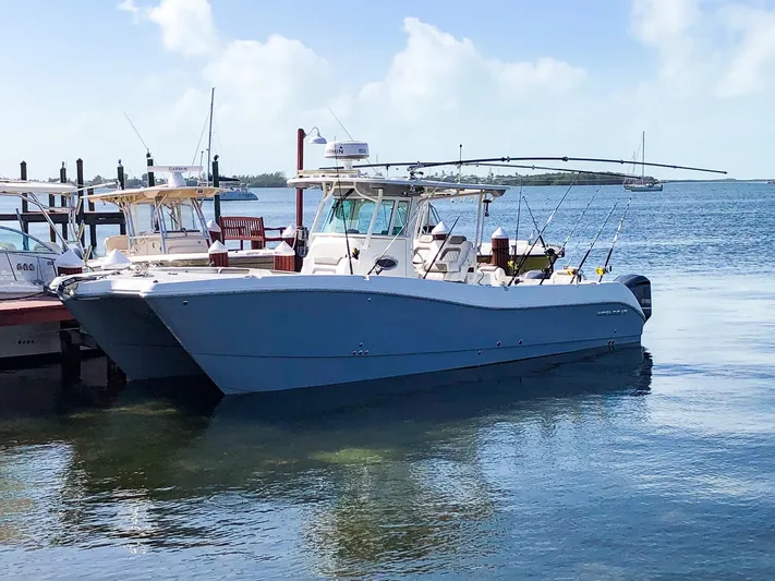  Yacht Photos Pics 2018 World Cat 320 CC boat docked by the water, equipped for fishing.