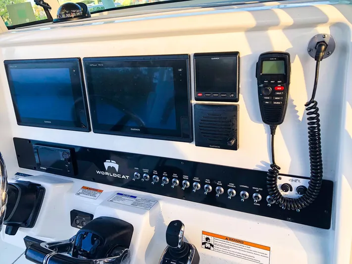  Yacht Photos Pics Control panel of 2018 World Cat 320 CC boat with Garmin displays and communication equipment.