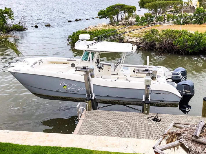  Yacht Photos Pics 2018 World Cat 320 CC boat docked by a scenic waterfront.
