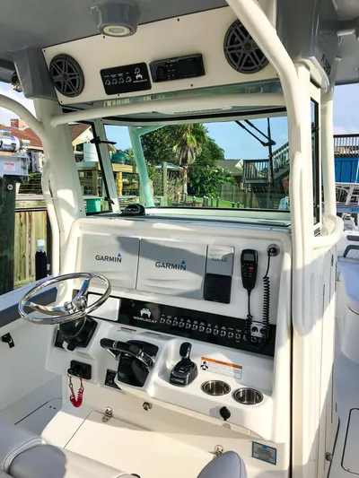  Yacht Photos Pics 2018 World Cat 320 CC boat dashboard with Garmin electronics and steering wheel.