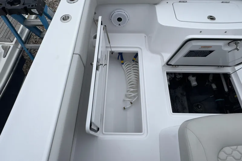  Yacht Photos Pics 2024 Jupiter 32 FS boat interior with storage compartments and coiled hose.