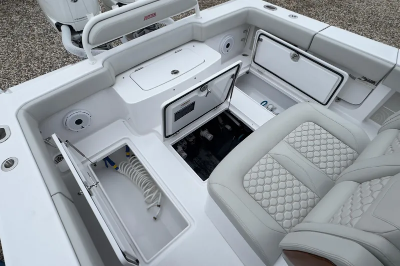 Yacht Photos Pics 2024 Jupiter 32 FS boat interior with storage compartments and cushioned seating.