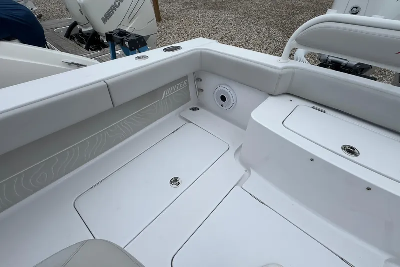  Yacht Photos Pics 2024 Jupiter 32 FS boat interior with white seating and storage compartments.