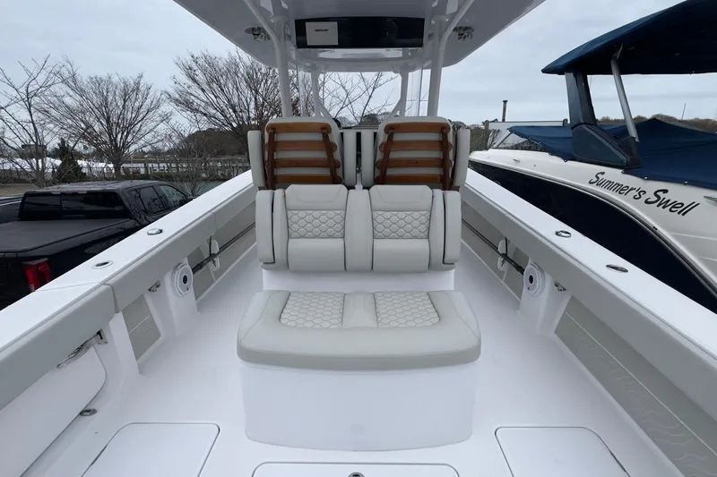  Yacht Photos Pics 2024 Jupiter 32 FS boat interior with cushioned seating and sleek design.