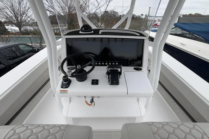  Yacht Photos Pics 2024 Jupiter 32 FS boat console with steering wheel and navigation display.