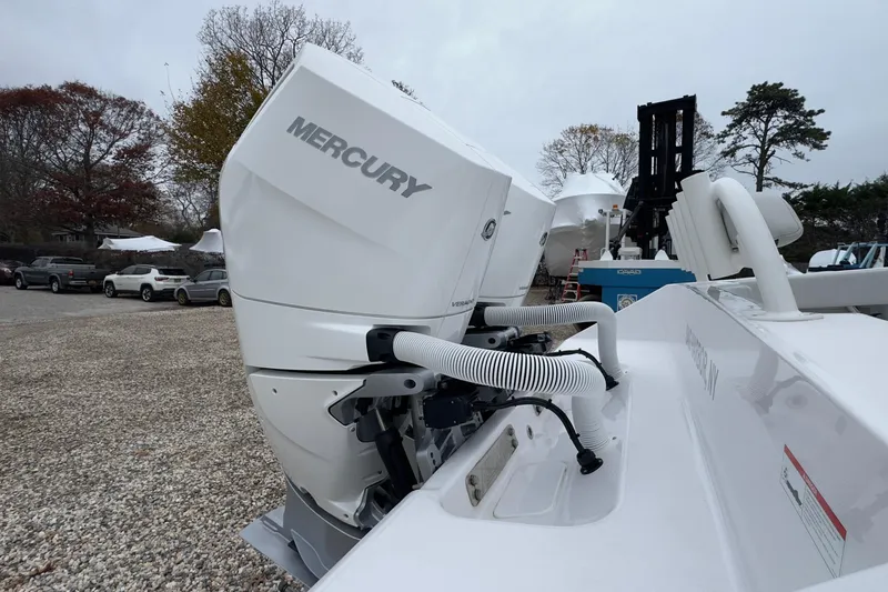  Yacht Photos Pics 2024 Jupiter 32 FS boat with Mercury outboard engine in a gravel lot.