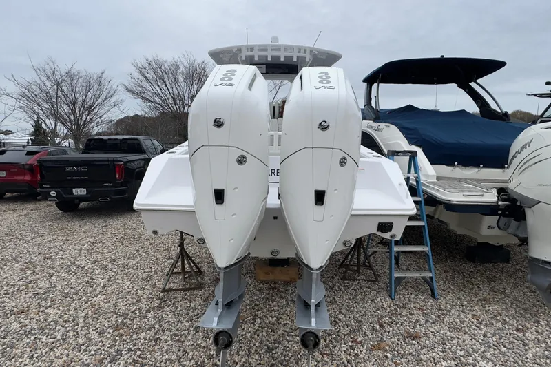  Yacht Photos Pics 2024 Jupiter 32 FS boat with dual outboard engines on gravel lot.