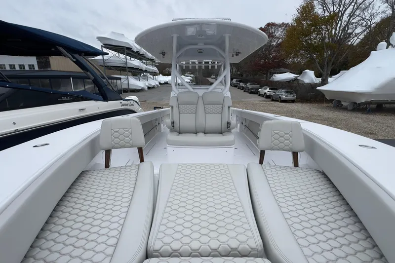  Yacht Photos Pics 2024 Jupiter 32 FS boat with luxurious seating and modern design in a marina setting.
