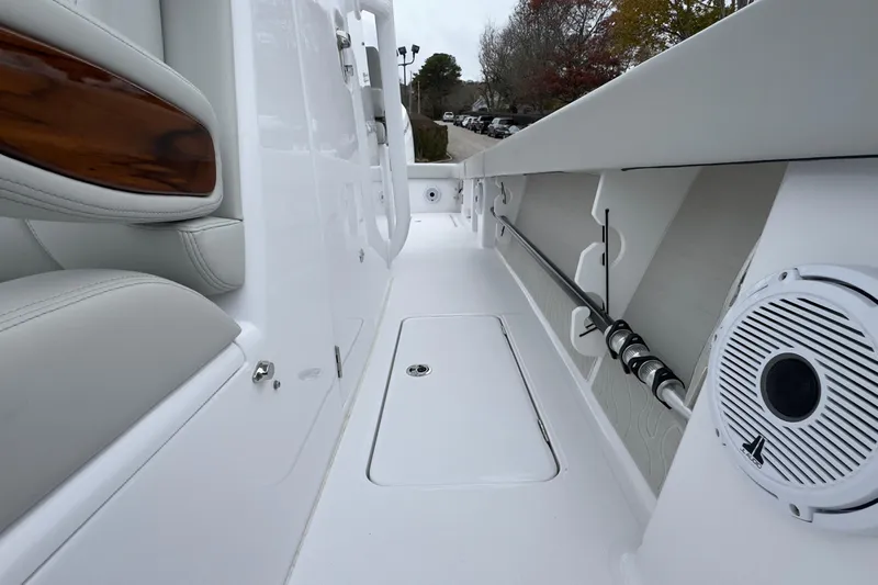  Yacht Photos Pics 2024 Jupiter 32 FS boat interior with white seating, rod holders, and speaker.