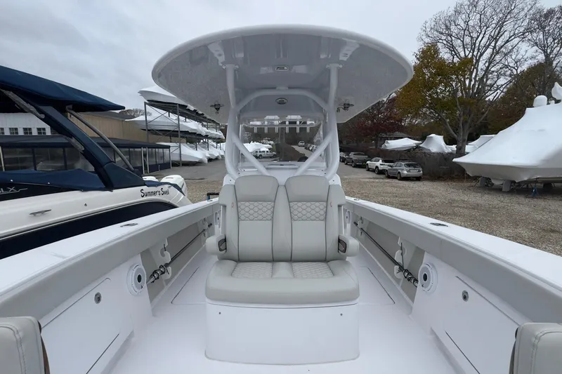  Yacht Photos Pics 2024 Jupiter 32 FS boat interior with seating and console, docked outdoors.